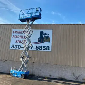 Scissor lift near forklift sales sign.