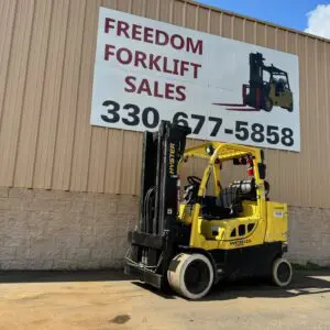 Yellow forklift outside sales building.