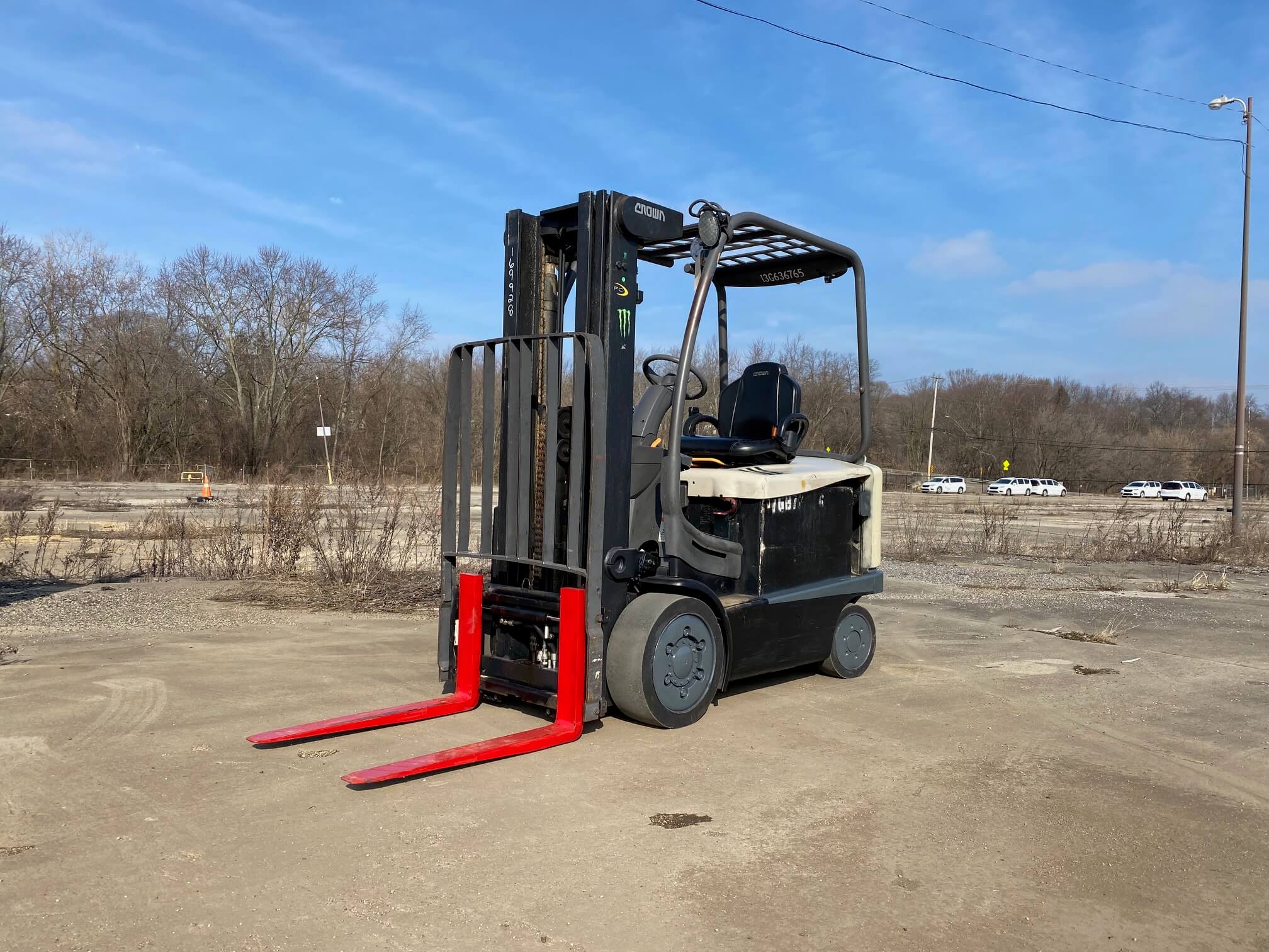 A fork lift is parked in the dirt.